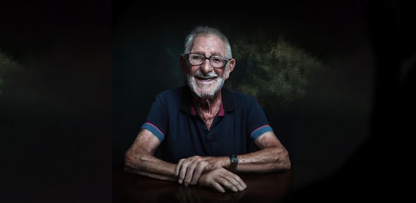 An AI generated image of a retirement-age man smiling.