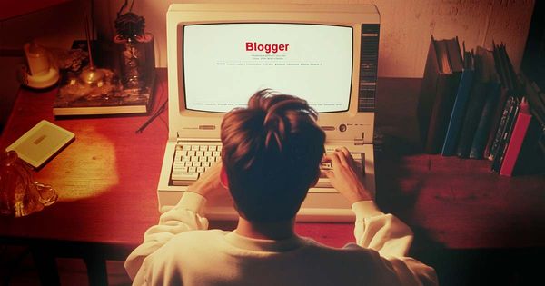 Am image of a fellow typing on a computer from the mid-1990s. The Blogger website is loading.